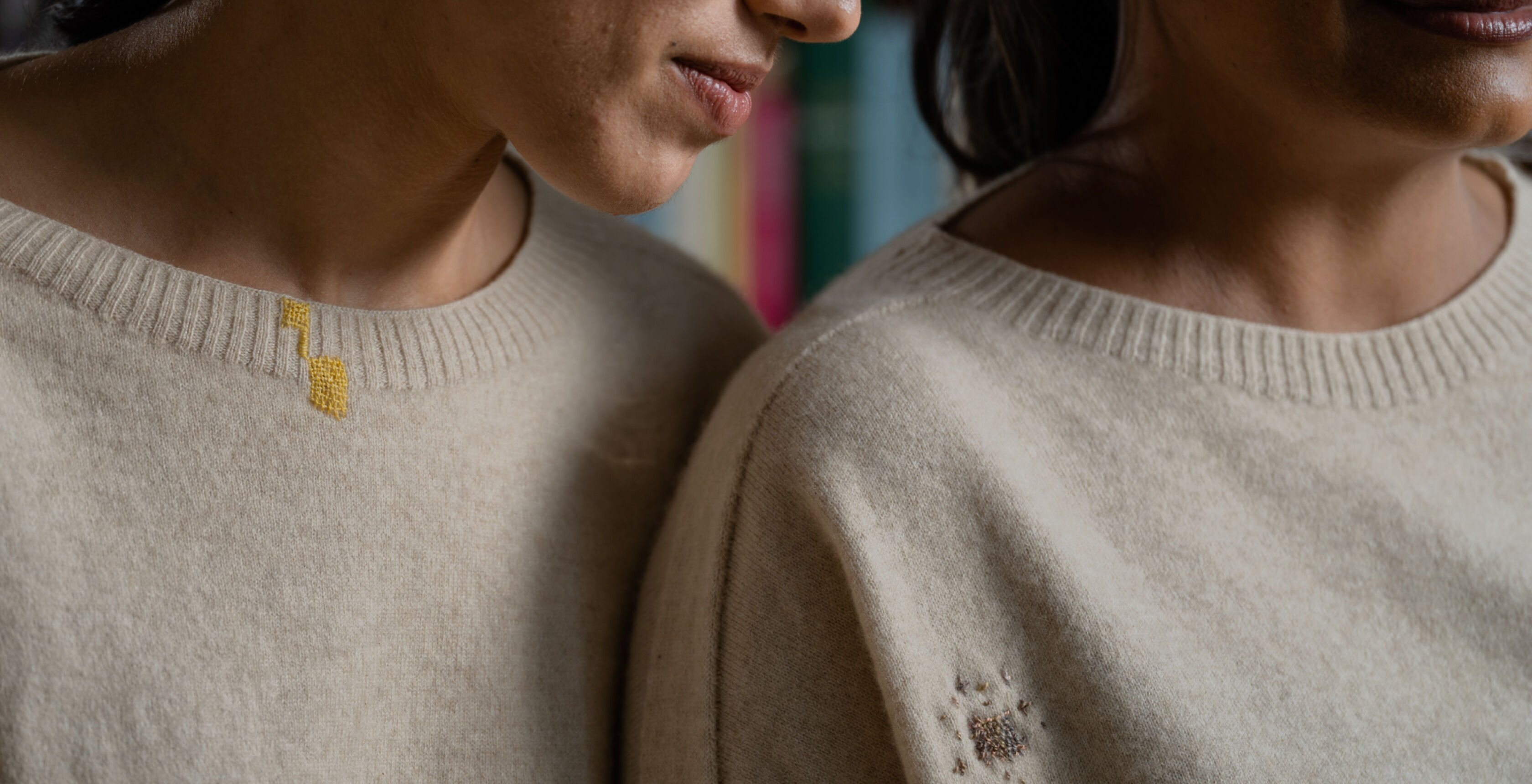 Women wearing sweaters with visible mending.